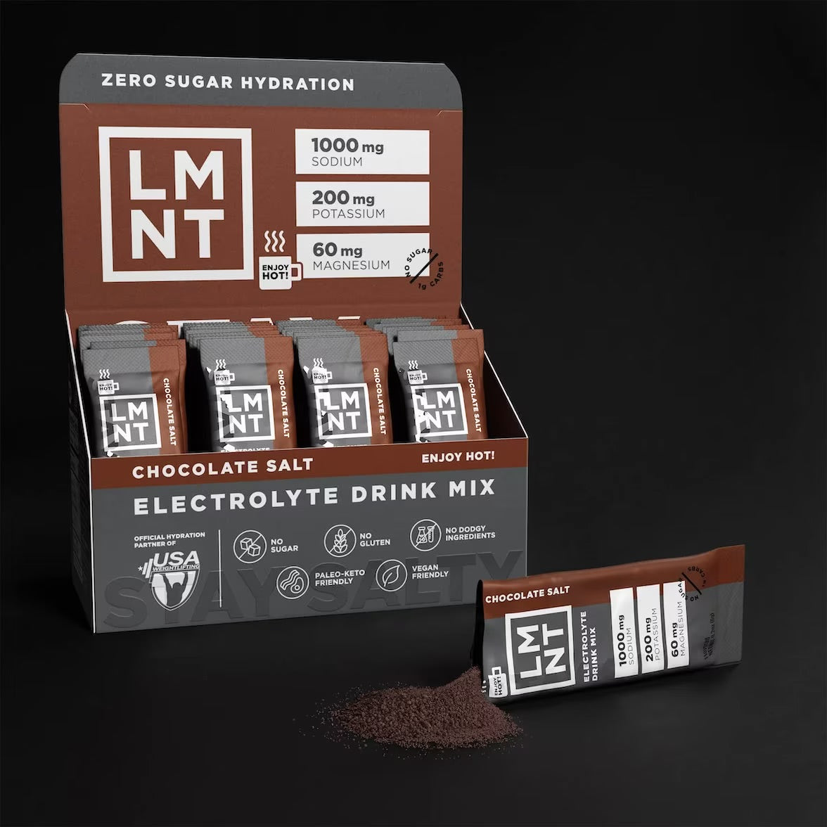 Open box of LMNT Chocolate Salt stick packs with one sachet beside a small pile of chocolate drink mix powder.