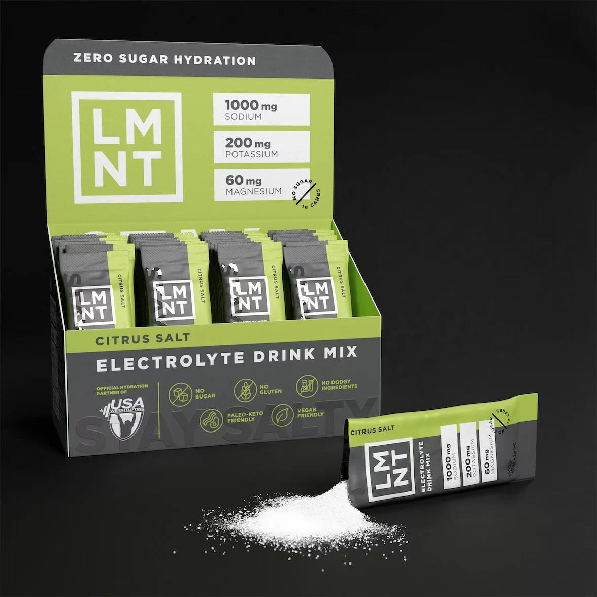 Open box of LMNT Citrus Salt electrolyte drink mix with individual sachets and a sachet beside a pile of powder